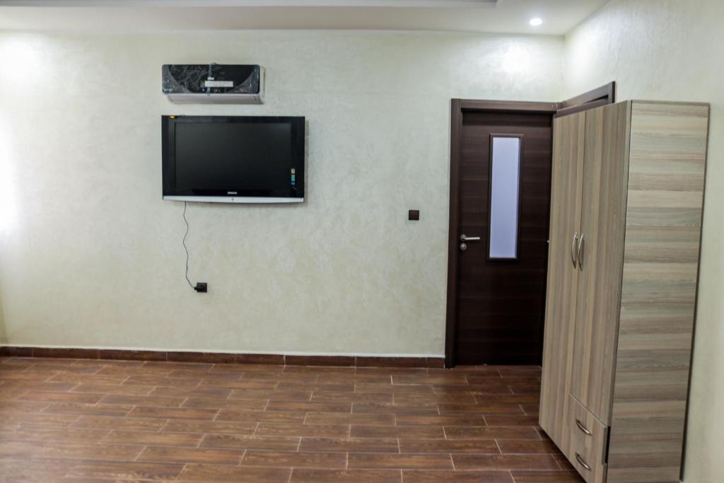 a room with a flat screen tv on a wall at HOTEL BORJ EL ARAB in Khouribga