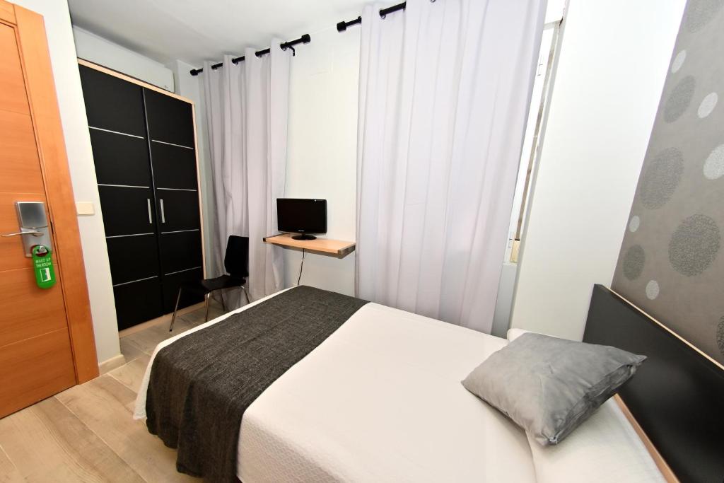 Cama o camas de una habitación en Hostal Falfes