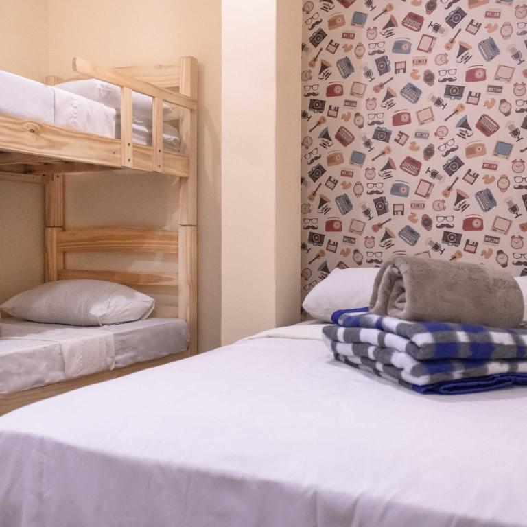 a bedroom with two bunk beds and a wall at HOSTEL CUARTO in Sao Paulo