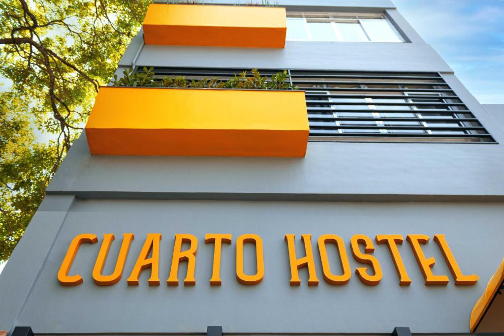 a sign on the side of a corona hospital building at HOSTEL CUARTO in Sao Paulo