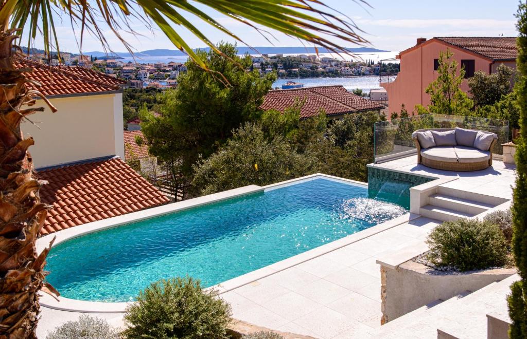 a swimming pool on top of a house at Villa Nerium in Seget Vranjica