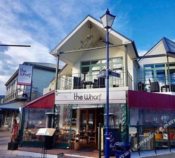 a building with a street light in front of a store at The Wharf Seaview Apartments by AVI in Akaroa