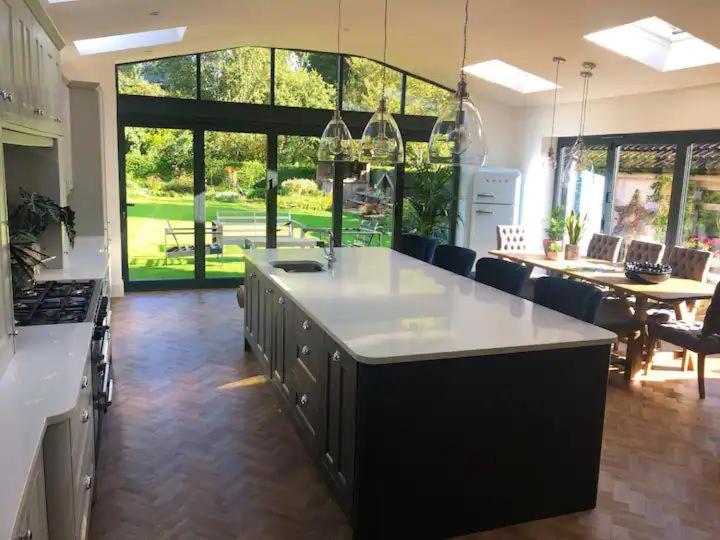 a kitchen with a large island in the middle of a room at HAYFIELD COTTAGE spacious detached luxury home in Copmanthorpe