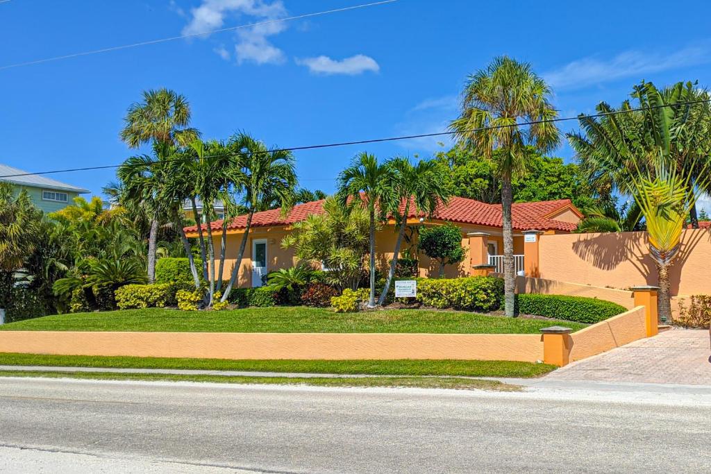 a house on a street with palm trees at Beach Villa 1B in Holmes Beach