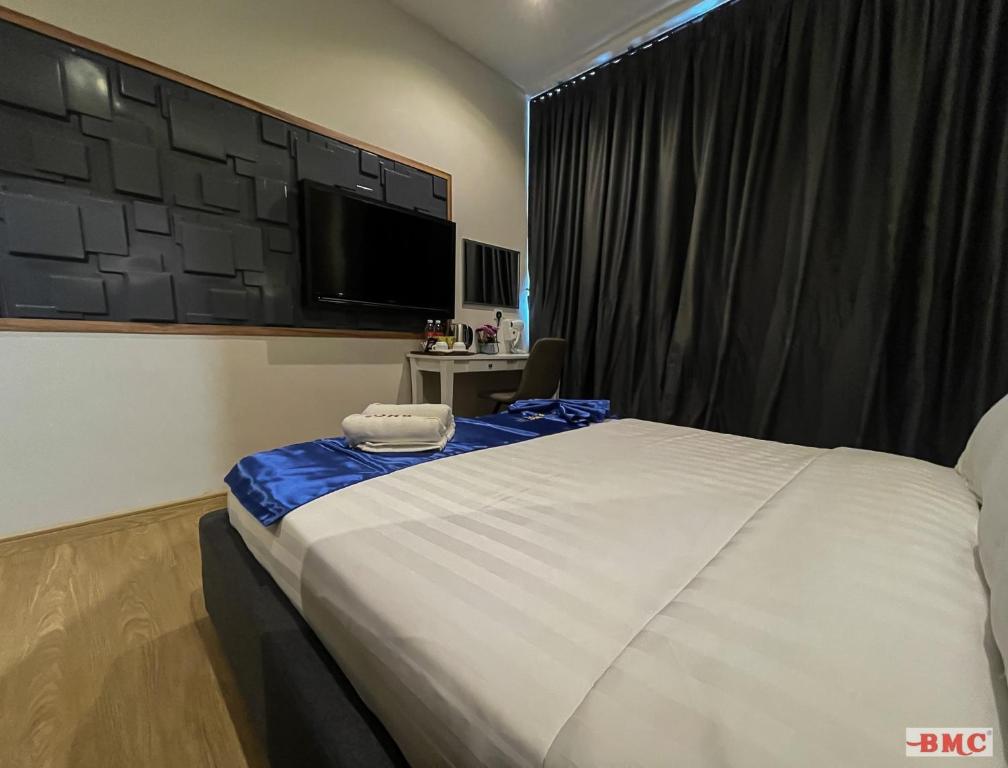 Postel nebo postele na pokoji v ubytování BMC Hotel