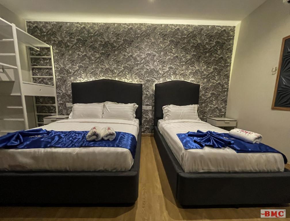 Postel nebo postele na pokoji v ubytování BMC Hotel