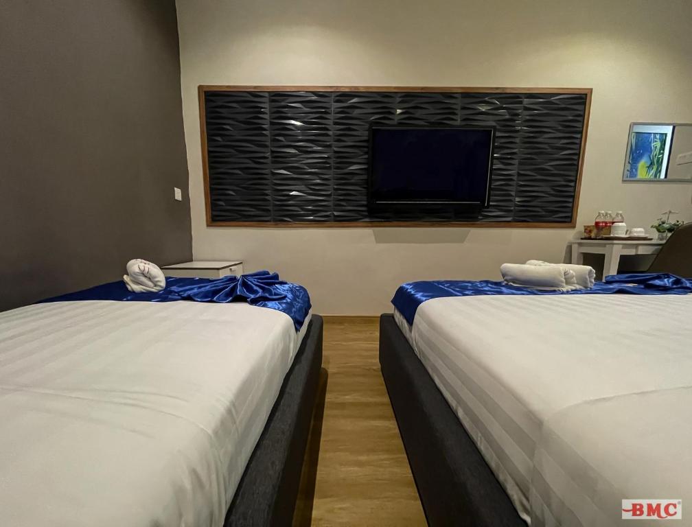 Postel nebo postele na pokoji v ubytování BMC Hotel