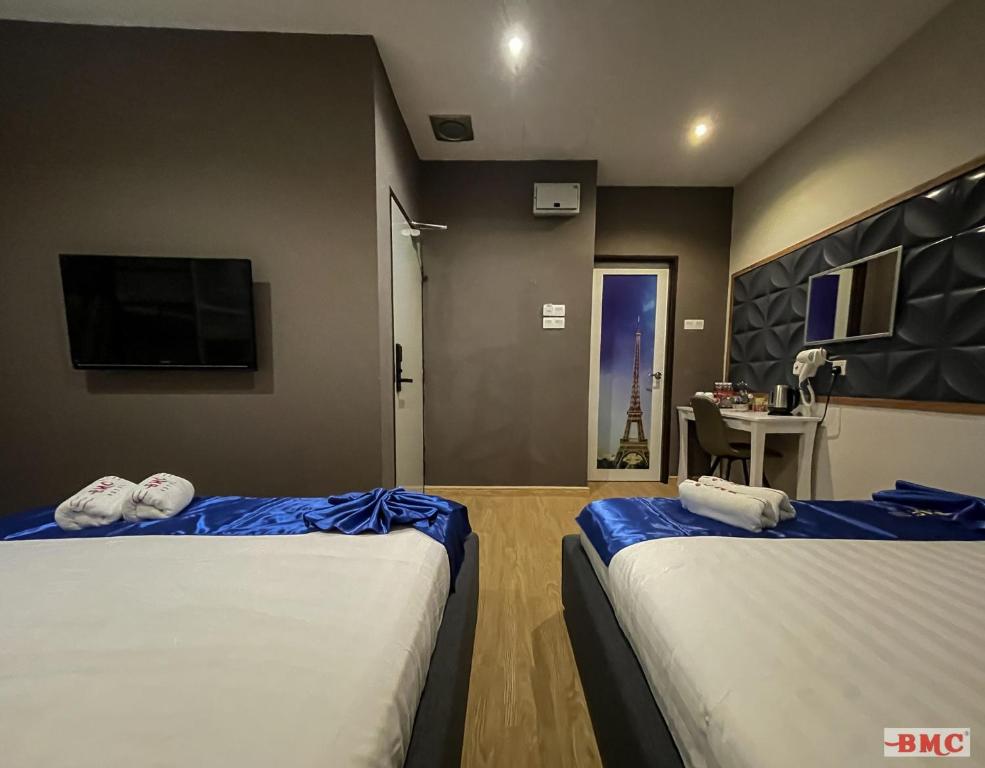 Postel nebo postele na pokoji v ubytování BMC Hotel