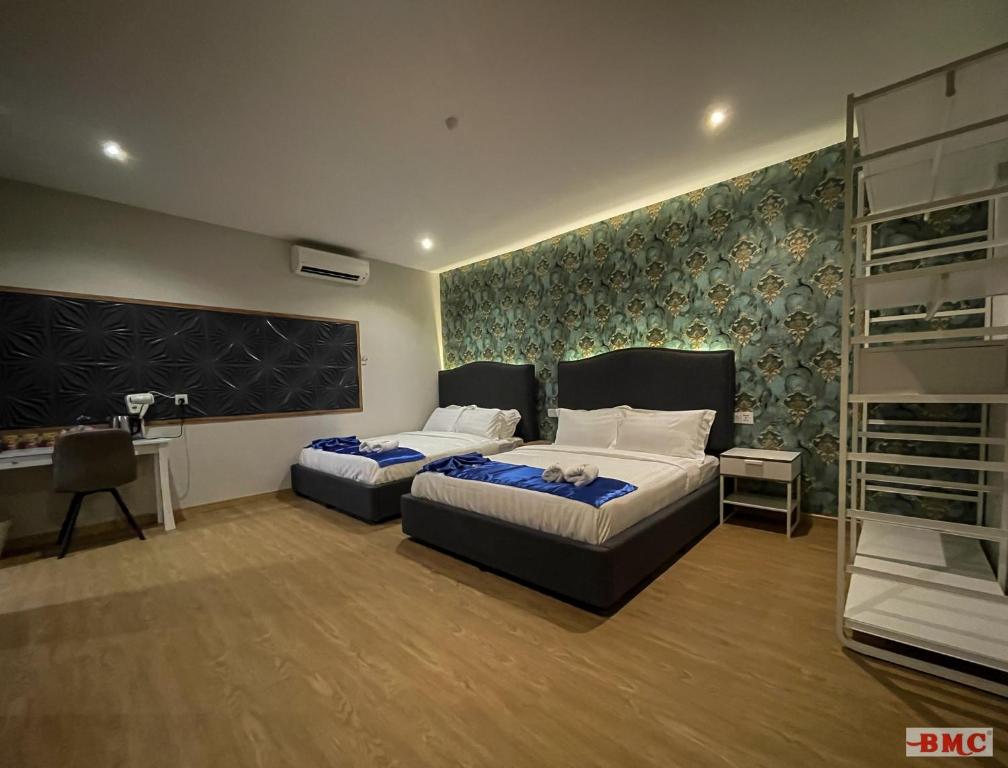 Postel nebo postele na pokoji v ubytování BMC Hotel