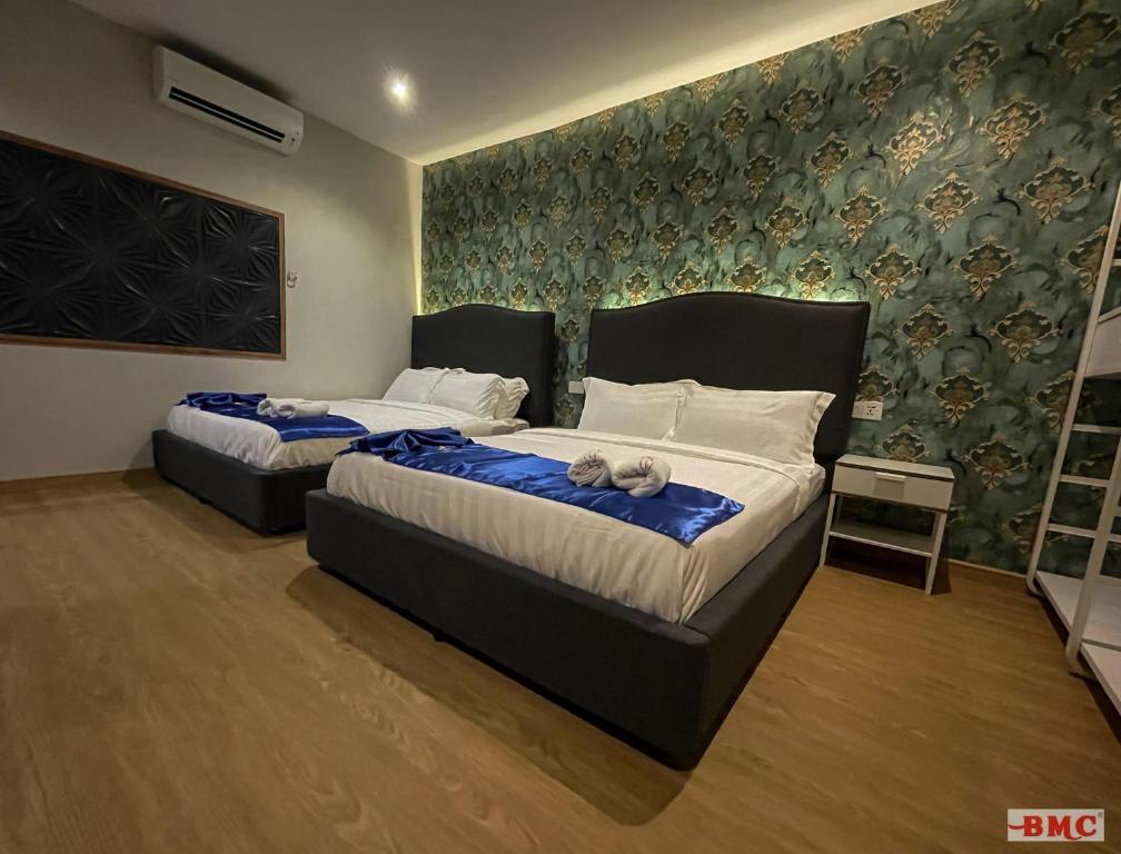 Postel nebo postele na pokoji v ubytování BMC Hotel