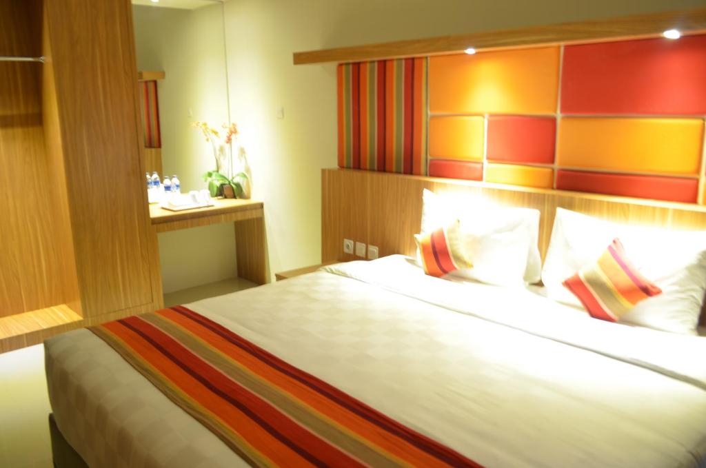 a bedroom with a large bed in a room at Kyriad Hotel Airport Jakarta in Tangerang