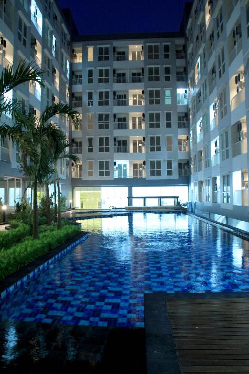 a swimming pool in the middle of a building at night at Kyriad Hotel Airport Jakarta in Tangerang