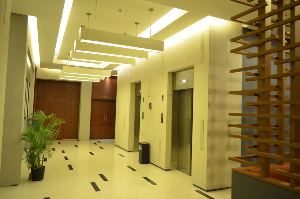 a hallway of an office building with a staircase at Kyriad Hotel Airport Jakarta in Tangerang