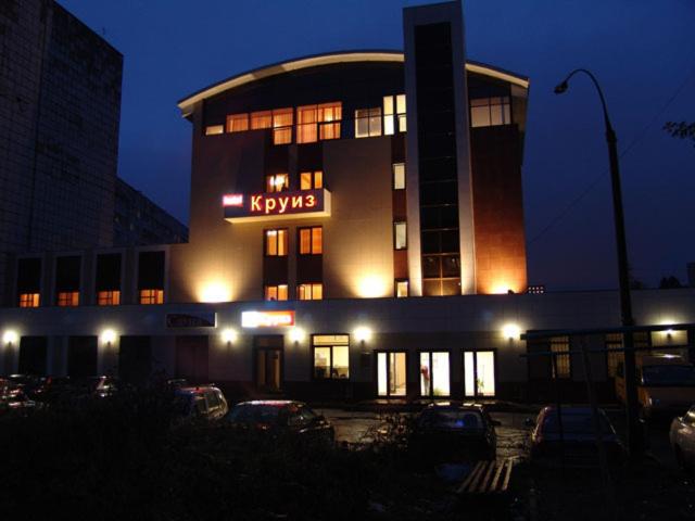 a building with a kryptonia sign on it at night at Cruise Hotel in Perm