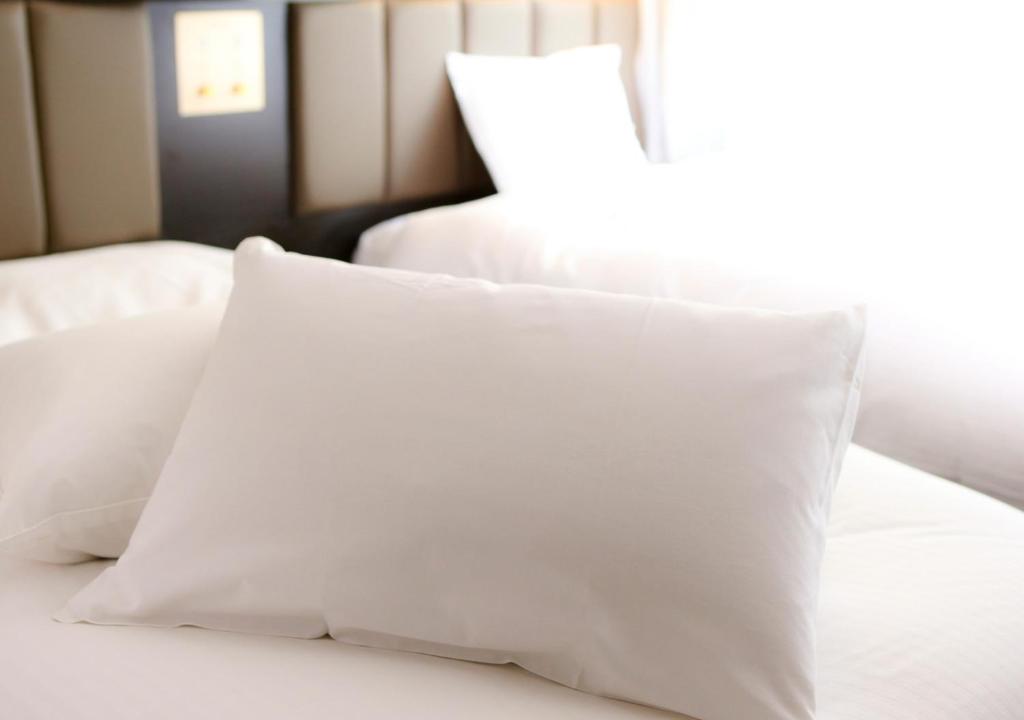 Tempat tidur dalam kamar di APA Hotel Nagasaki Ekimae