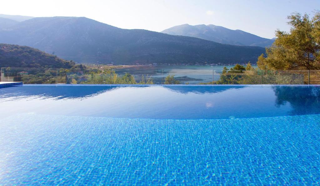a swimming pool with a view of the mountains at Villa Theia in Katokhórion