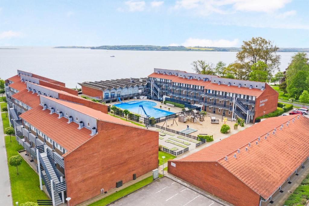 an overhead view of a building with a swimming pool at By the sea - Linen and towels included in Fåborg