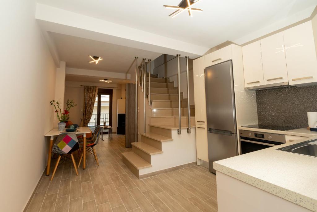 a kitchen and dining room with a staircase in a apartment at Comfy & stylish apt in Ioannina with fireplace in Ioannina