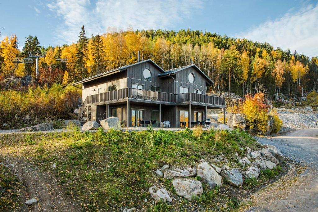 a large house on a hill with a road at Villabranten! Ski In - Ski Out, Bike In - Bike Out in Järvsö