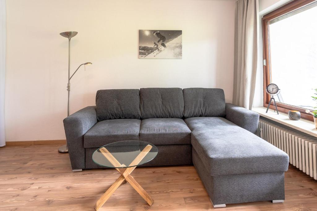 a living room with a couch and a glass table at Alpenblume in Fischen