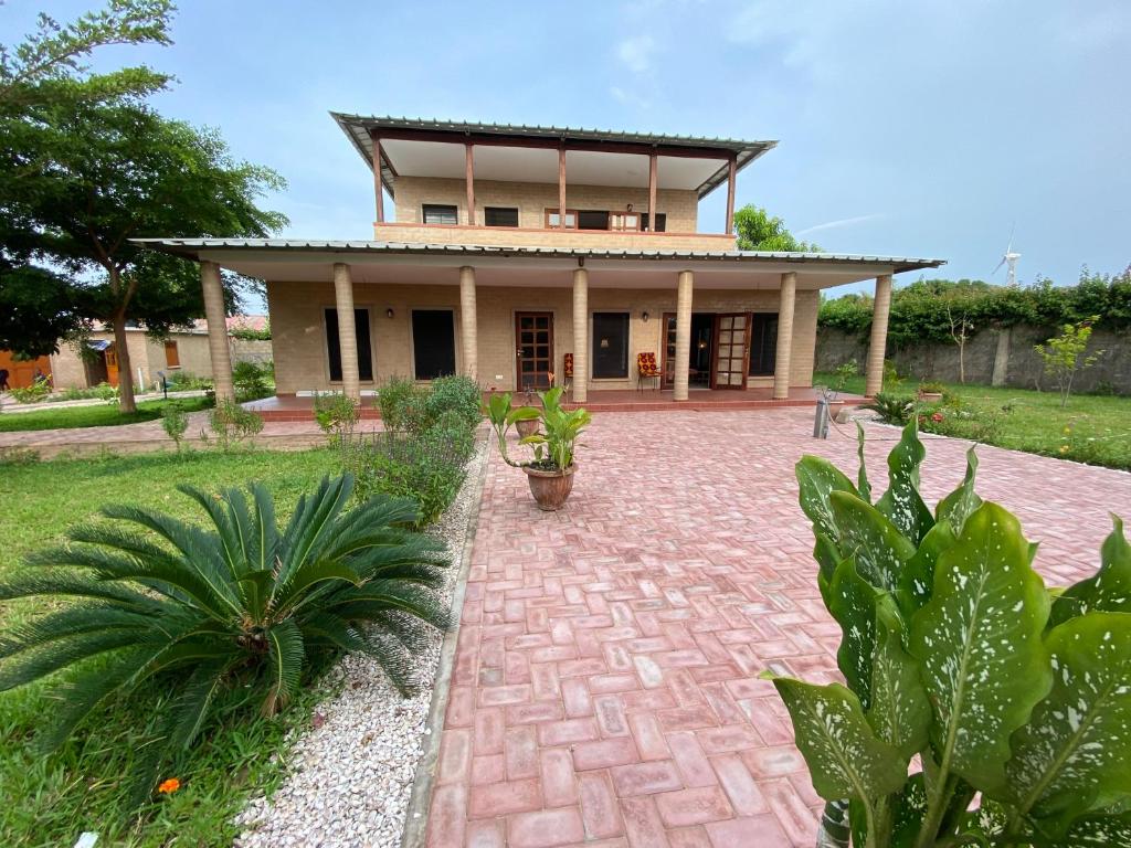 a house with a brick driveway in front of it at Ama Batokunku Resort in Batukunku