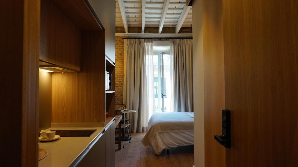 Łóżko lub łóżka w pokoju w obiekcie San Jorge Suites Triana