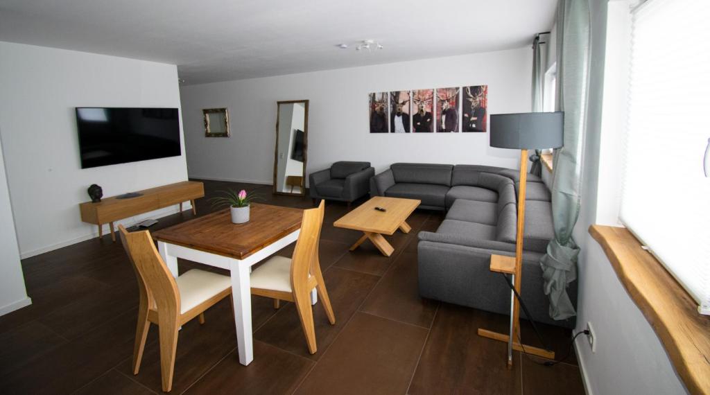 a living room with a couch and a table at unique flat in Düsseldorf