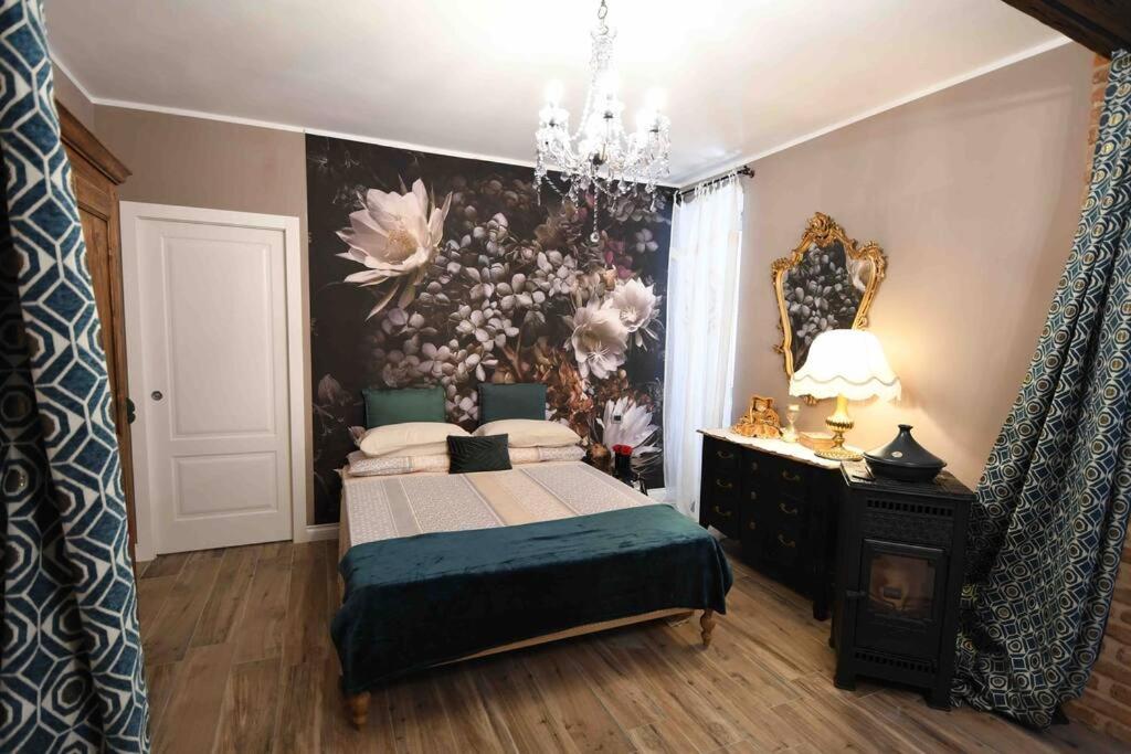 a bedroom with a bed and a painting on the wall at Loft incantevole Casa Sugnat in Novello