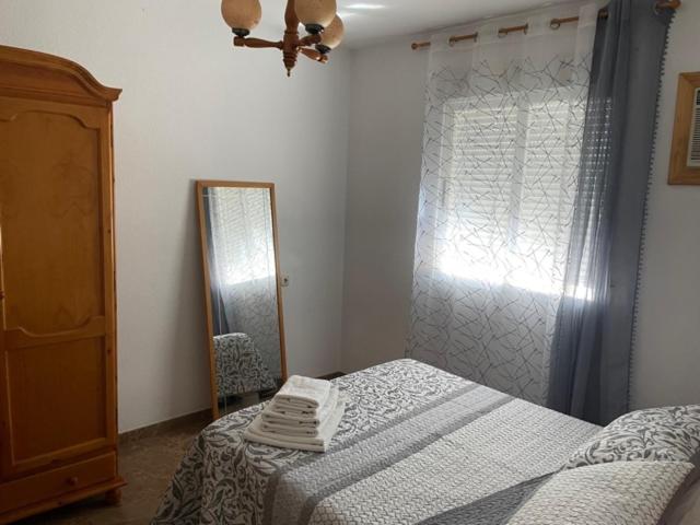 Postel nebo postele na pokoji v ubytování Apartamentos Coronichi