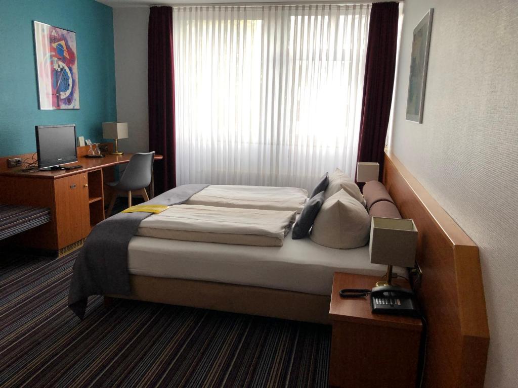 Postel nebo postele na pokoji v ubytování Hotel Servatius