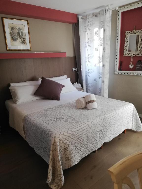 a bedroom with a bed with two stuffed animals on it at B & B San Domenico in Chioggia