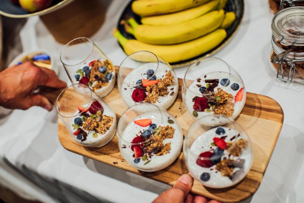 a plate of food on a cutting board with snacks at Boutique Hotel Porto in Dubrovnik
