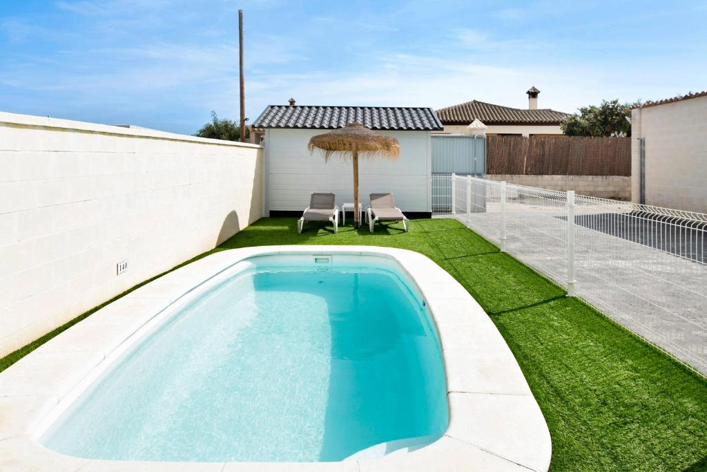 a swimming pool in the backyard of a house at Casa Manoli in Hozanejos