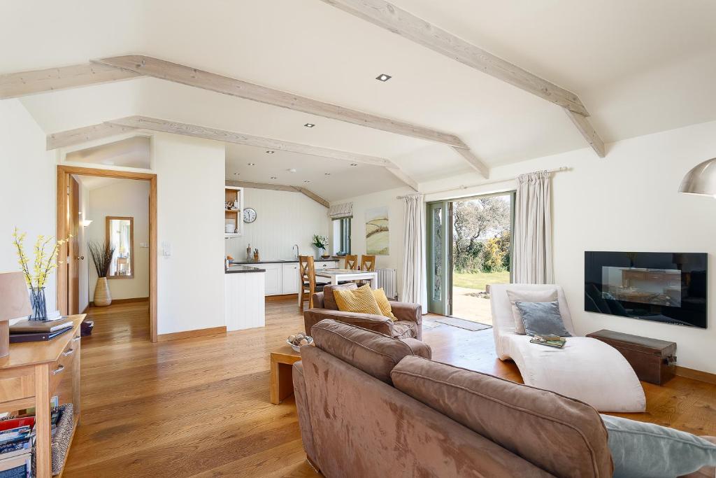 a living room with a couch and a table at The Granary at Cornish Barn Holidays in Truro