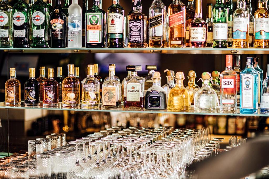 a bar with lots of bottles of alcohol on shelves at Boutique Hotel Porto in Dubrovnik