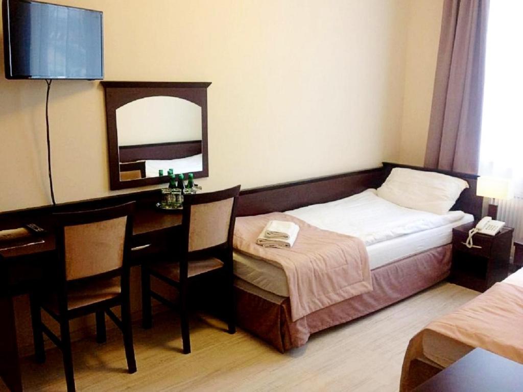 Posteľ alebo postele v izbe v ubytovaní Hotel Feniks