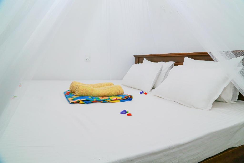 Postel nebo postele na pokoji v ubytování Sanda Hiru Guest