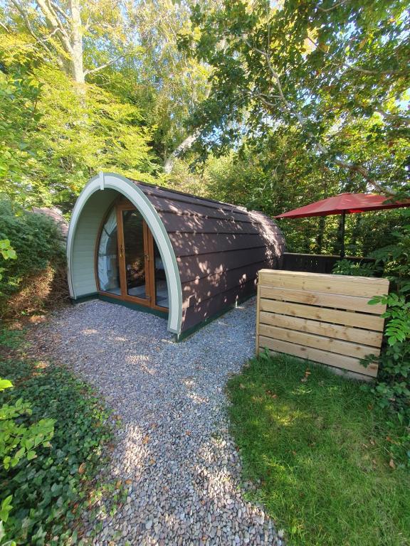 ein kleines Kuppelhaus mit einer Tür und einer Holzkiste in der Unterkunft Priory Glamping Pods and Guest accommodation in Killarney