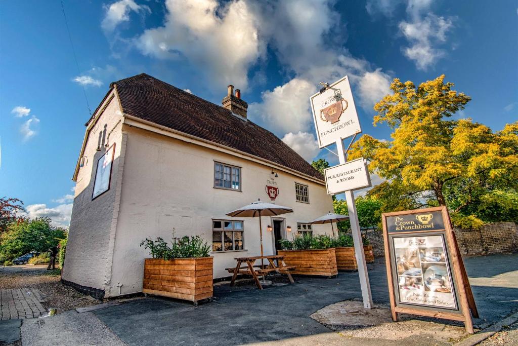 a small white building with a sign in front of it at Crown & Punchbowl in Cambridge