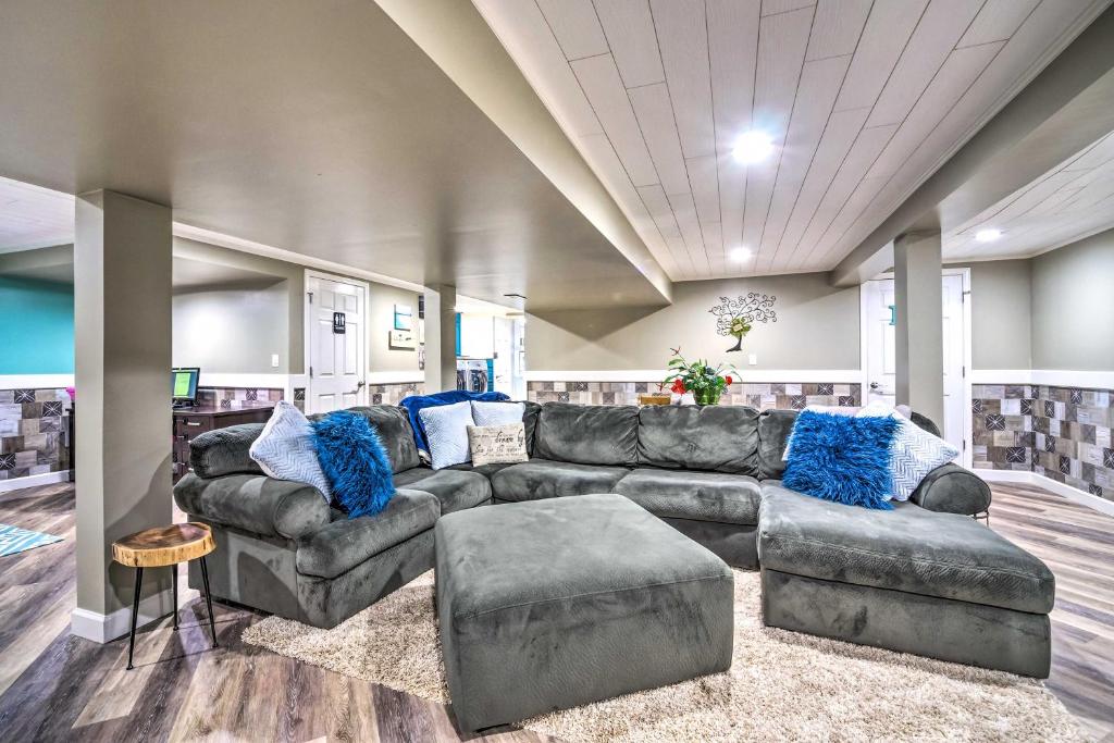 a living room with a leather couch and blue pillows at Mammoth Cave Rental on 50 Acres Shared Amenities in Cub Run
