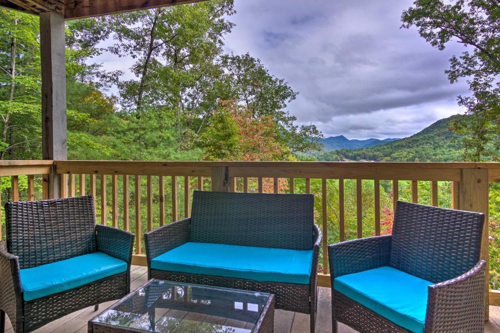 a deck with two chairs and a glass table at Studio Getaway with Mountain Views Near Breweries! in Franklin