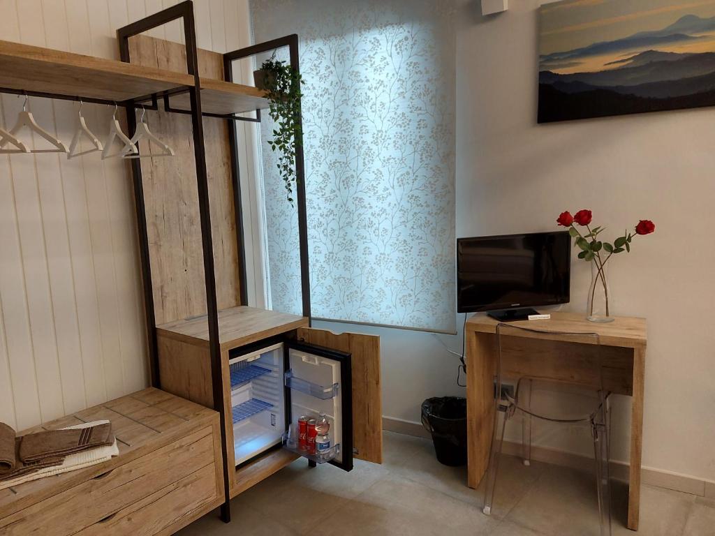 Televízia a/alebo spoločenská miestnosť v ubytovaní Casa Vacanze Piccolpasso 20