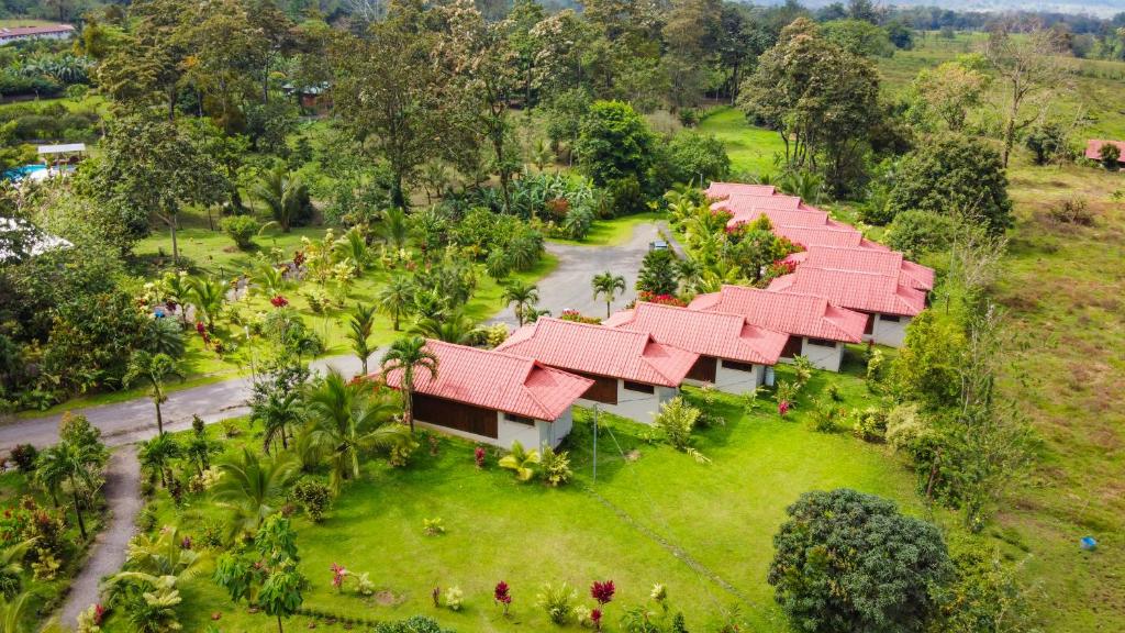 an aerial view of a resort with red roofs at Arenal History INN in Fortuna