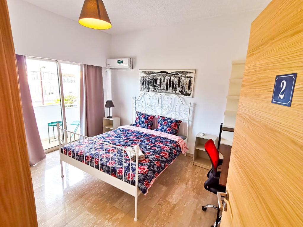 ein kleines Schlafzimmer mit einem Bett und einem Schreibtisch in der Unterkunft Central Square Nomadic Rooms in Larnaka