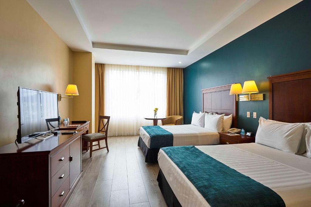 Postel nebo postele na pokoji v ubytování Sonesta Hotel Loja