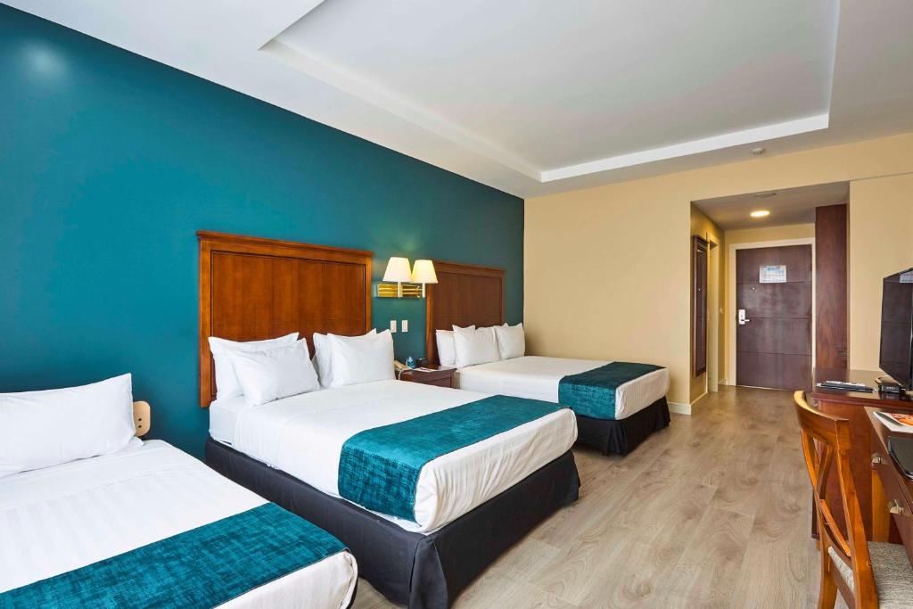 Postel nebo postele na pokoji v ubytování Sonesta Hotel Loja