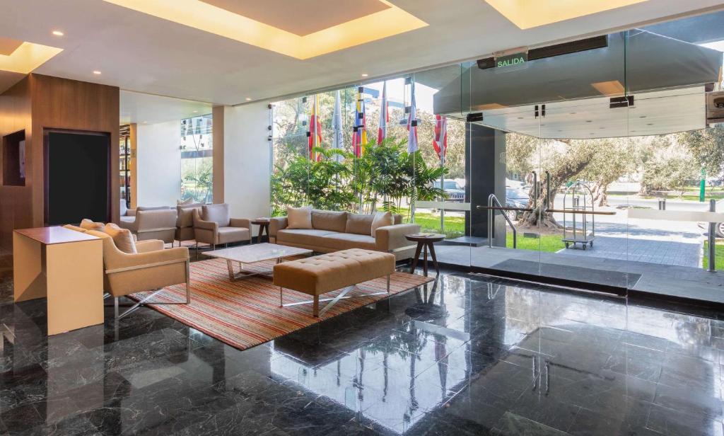 a living room with a pool in a building at Sonesta Hotel El Olivar in Lima