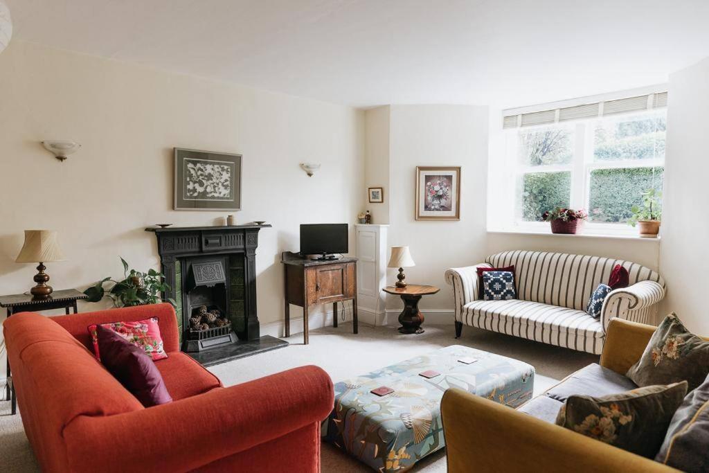 a living room with two couches and a fireplace at SUNNYSIDE APARTMENT - Spacious 2 Bedroom Ground Floor with Free Parking In Kendal, Cumbria in Kendal