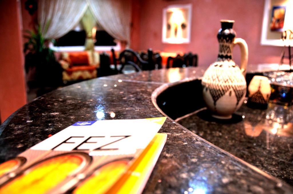 a table with a vase and a sign on it at Luxury Riad Saad Fes- Apart in Fès