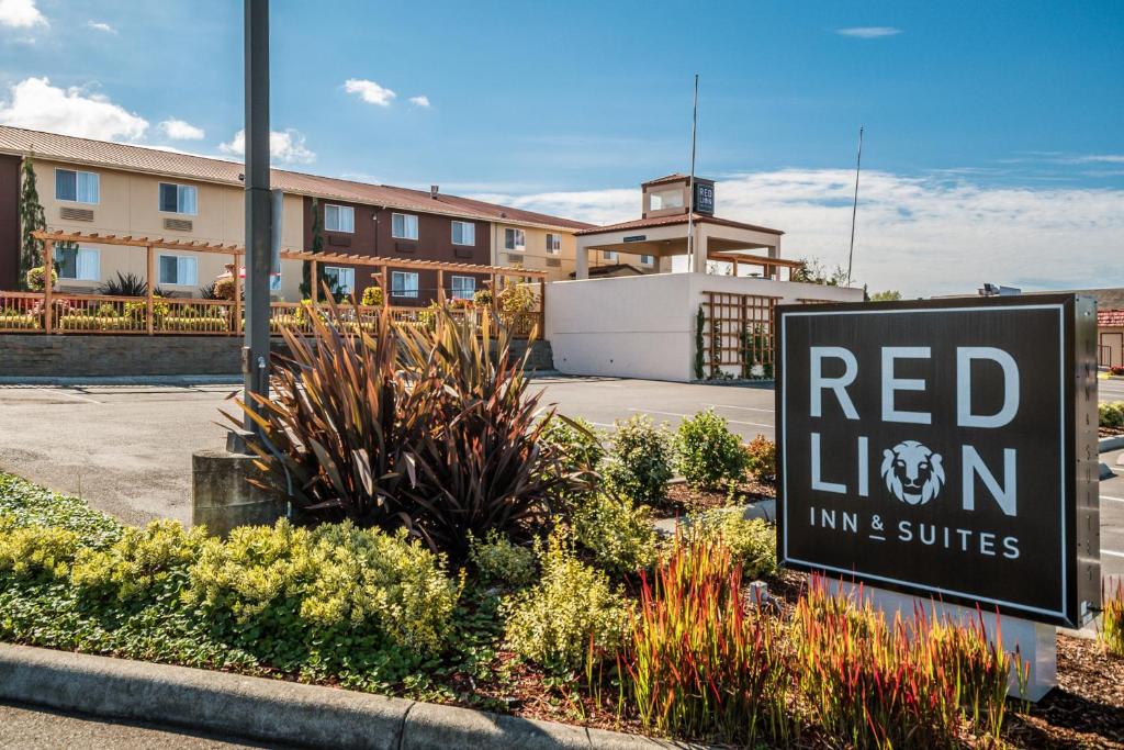 a red lion inn and suites sign in front of a building at Red Lion Inn & Suites at Olympic National Park in Sequim